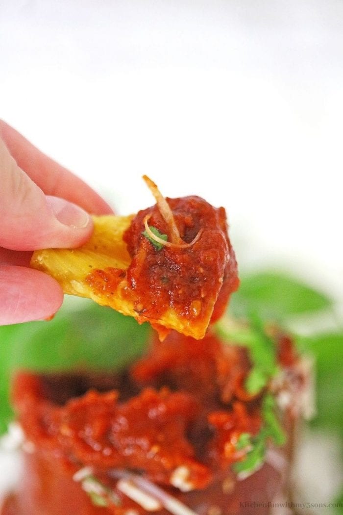 pasta chip being dipped in sauce