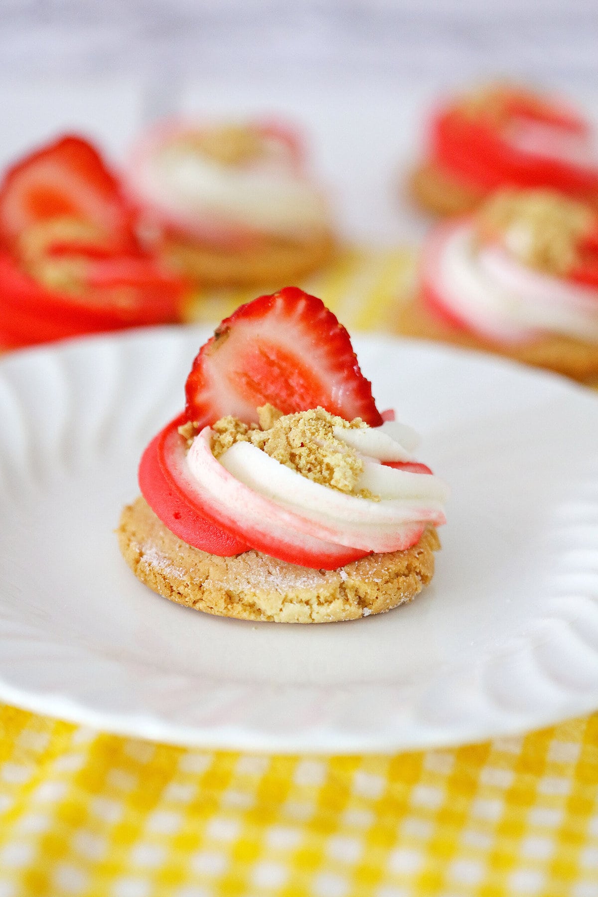 Frosted Strawberry Cheesecake Cookies on a plate