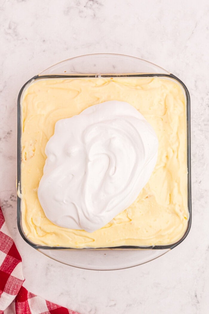 whipped cream on top of pudding  in a baking dish