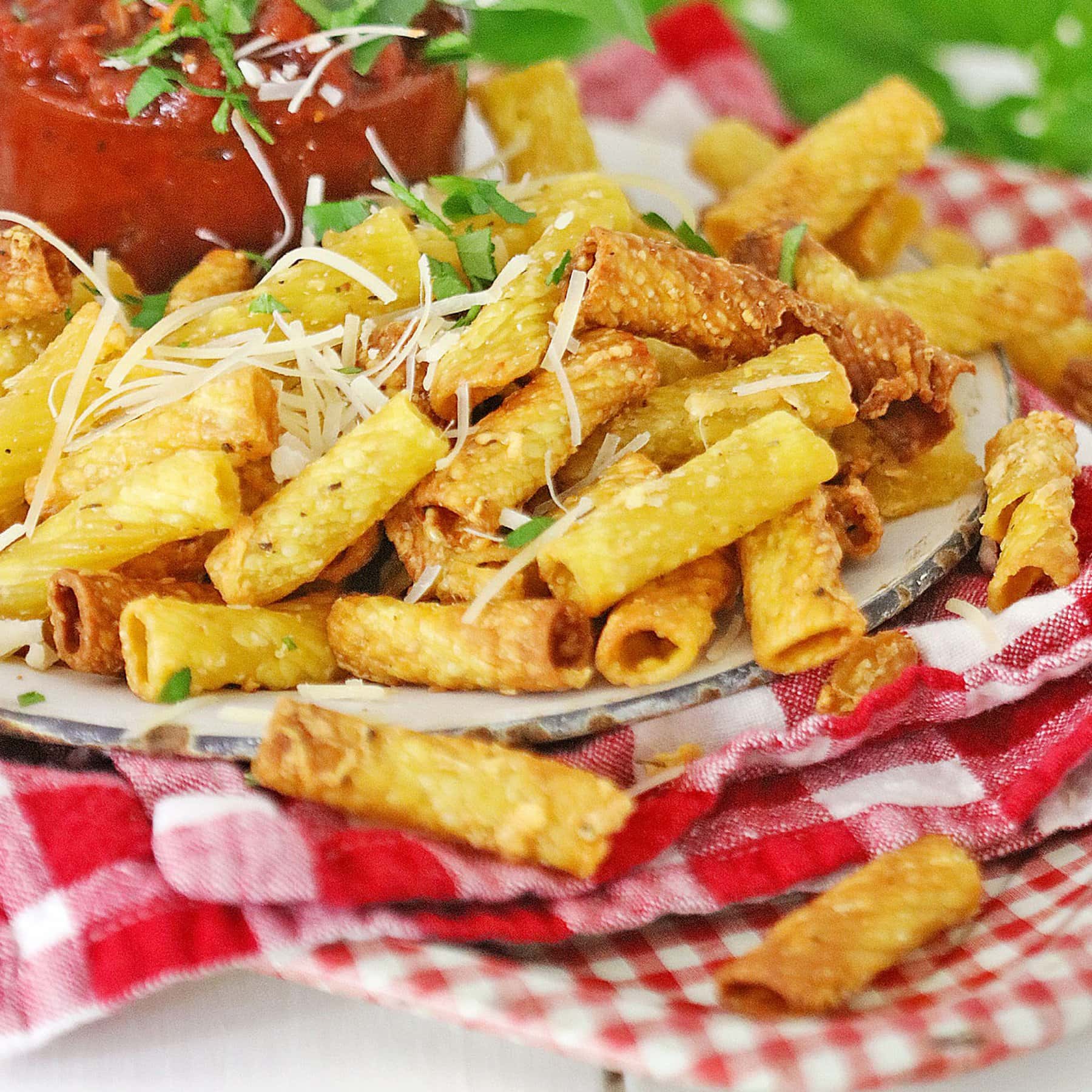 Air Fryer Pasta Chips on a plate over red plaid fabric