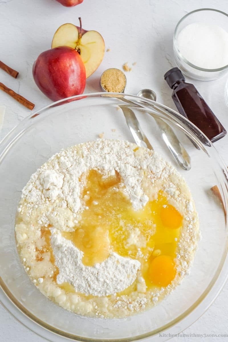 Adding the eggs into the flour.
