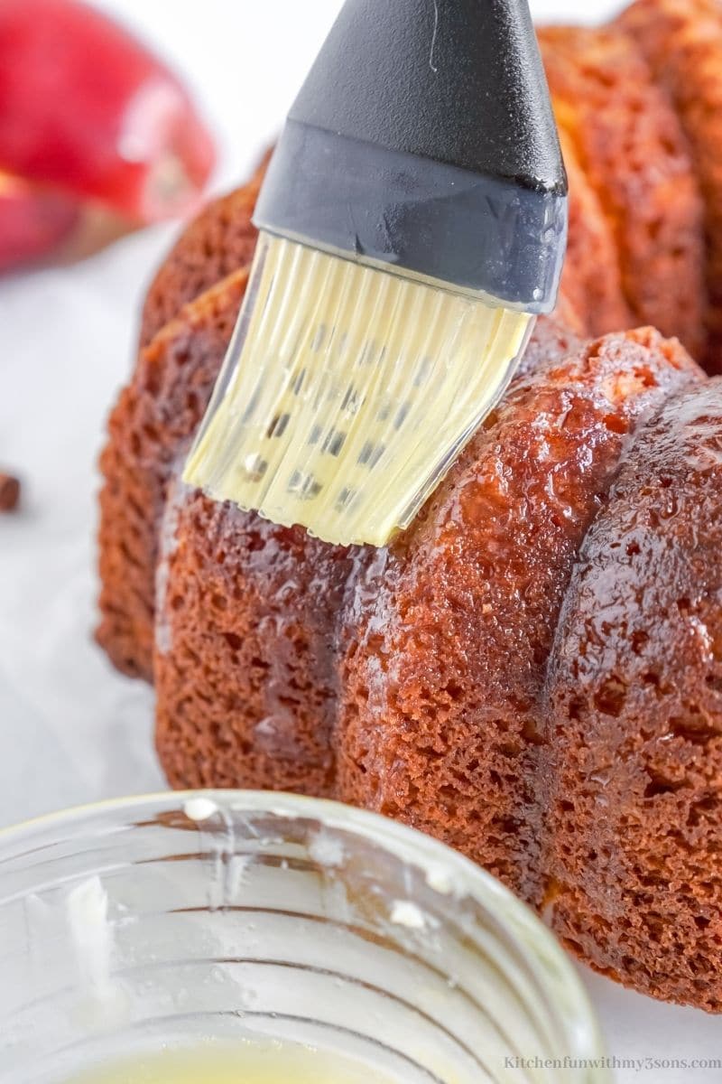 Brushing butter on to the cake.