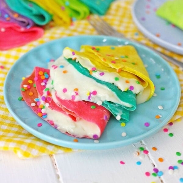 A couple of crepes with filling in them.