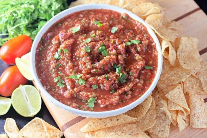 Homemade Salsa in a white bowl on a wood board.