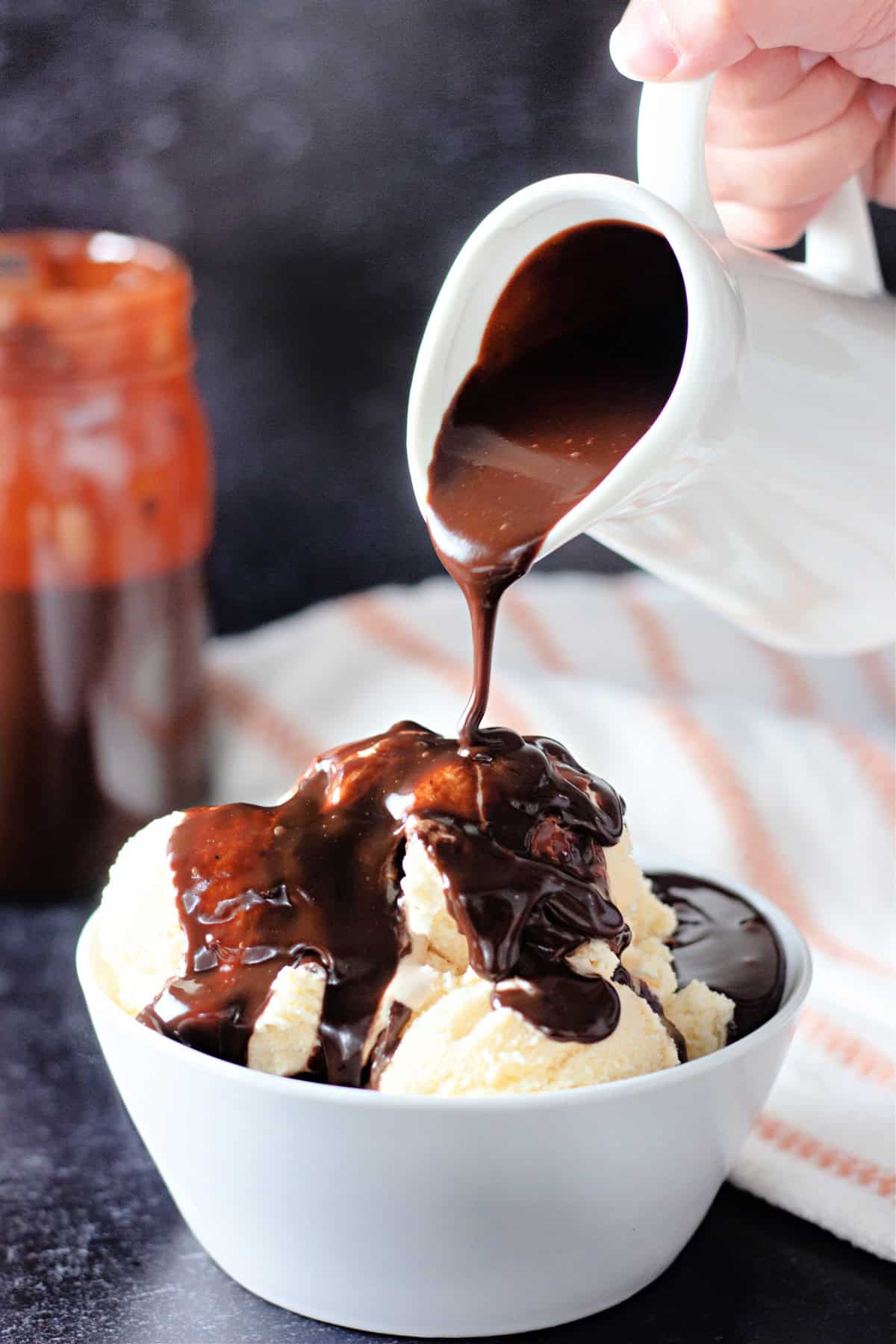 Ready in 5 minutes with just 6 basic ingredients, this Hot Fudge Sauce is rich, decadent, and incredibly chocolatey. Pouring hot fudge over a bowl of vanilla ice cream