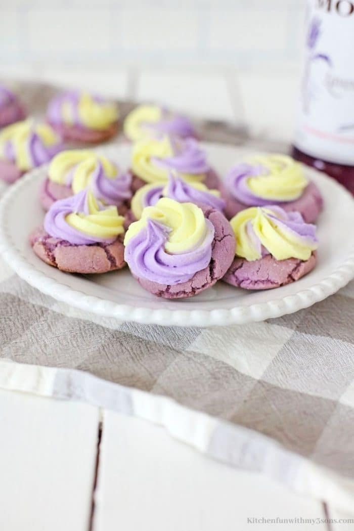 Some of the cookies topped with yellow and purple frosting.