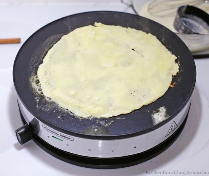Making the crepe on the crepe maker.