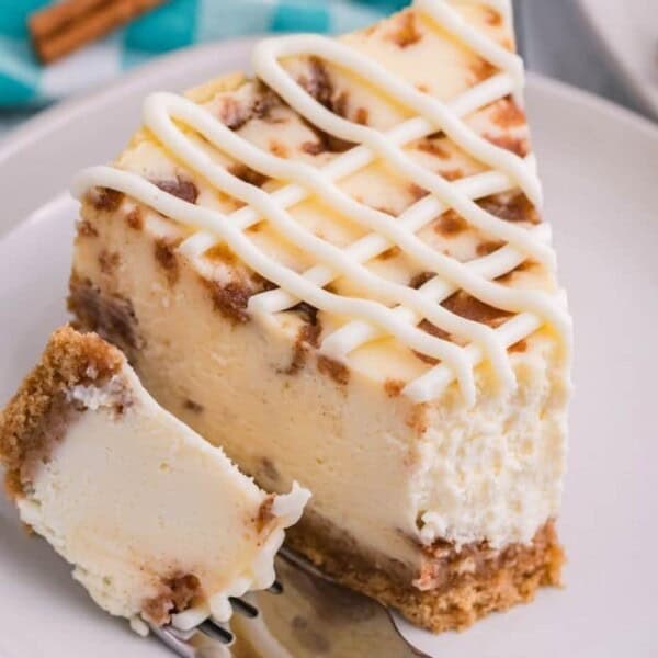 A piece of cheesecake with a bite taken out.