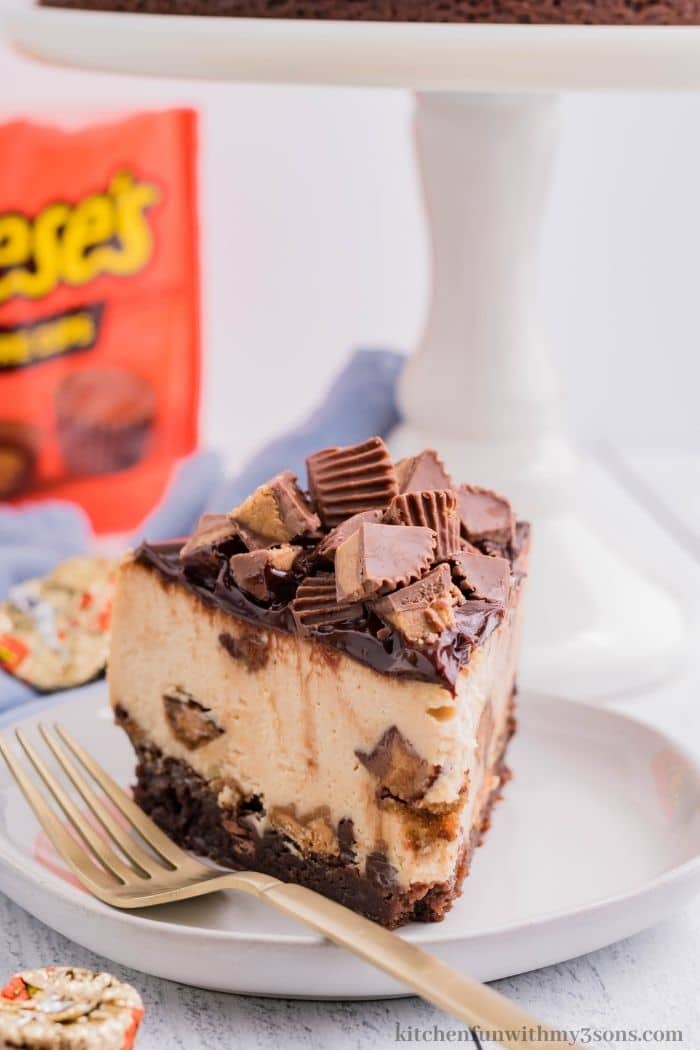A piece of Reese's peanut butter cheesecake on a serving plate.
