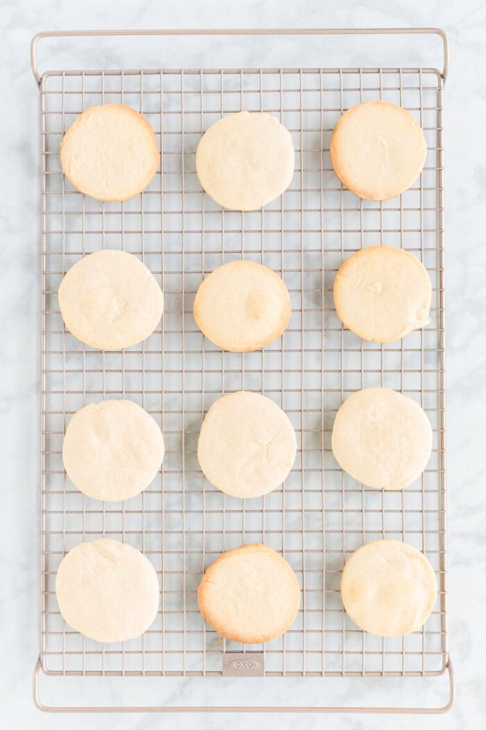 Round shortbread cookies on a cooling rack