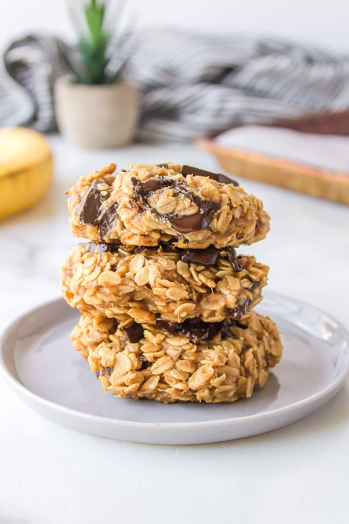 A stack of three breakfast cookies on a plate.