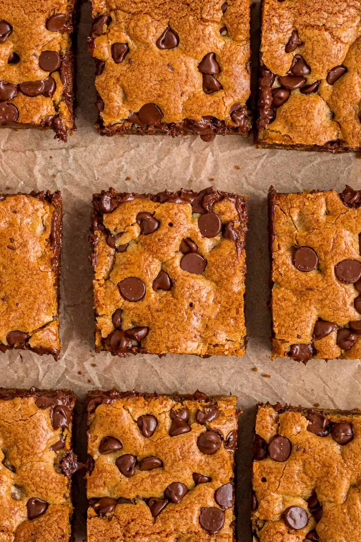 Overhead view of chocolate chip cookie bars on parchment paper
