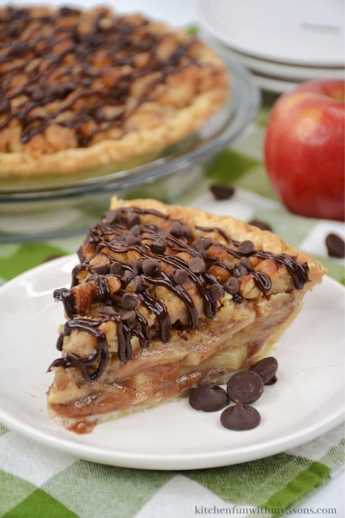 A piece of the apple crumble pie with mini chocolate chips on top.