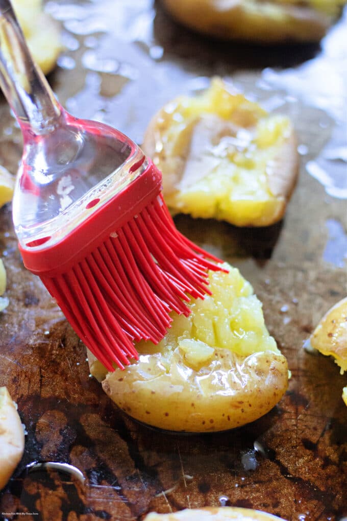 brushing olive oil over the potato