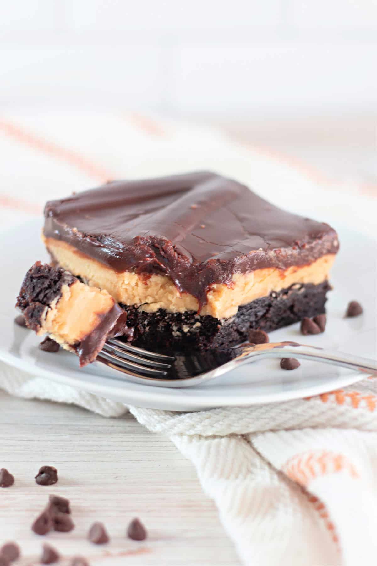 A buckeye brownie on a white plate with a bite on a fork