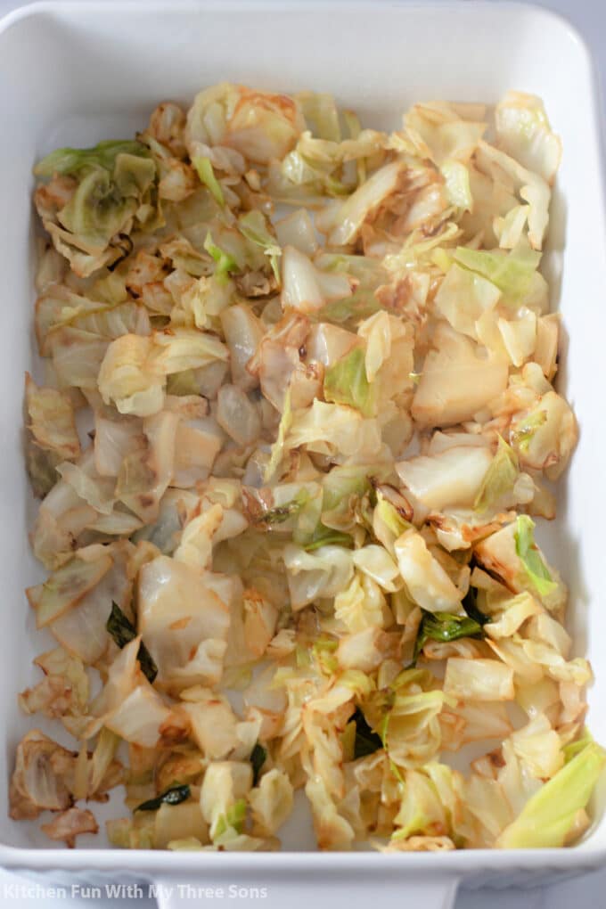 freshly sautéed cabbage in a white casserole dish.