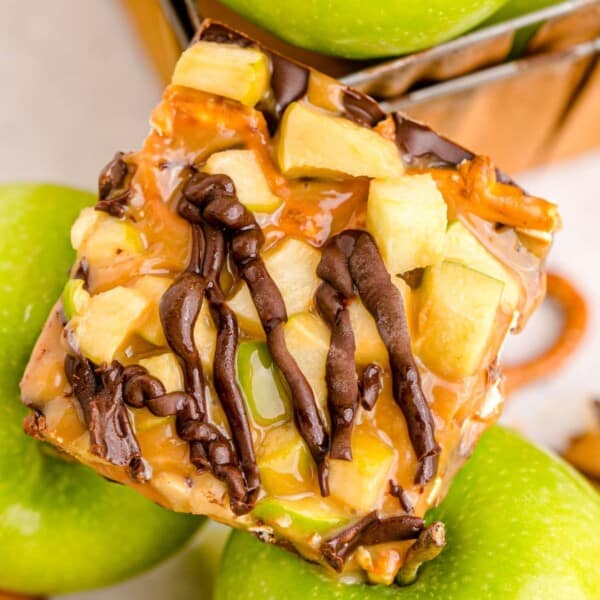 caramel apple bark on two green apples