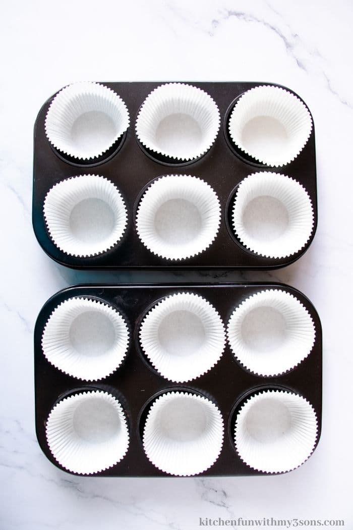 Placing liners in the muffin tin.