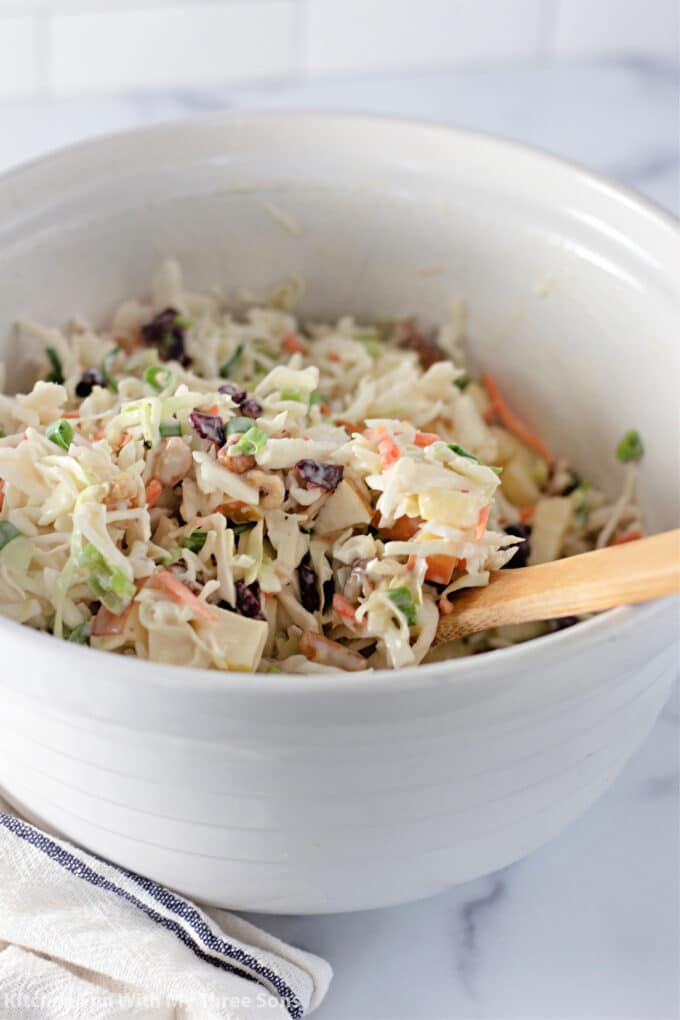 freshly tossed Cranberry Apple Coleslaw in a white mixing bowl.