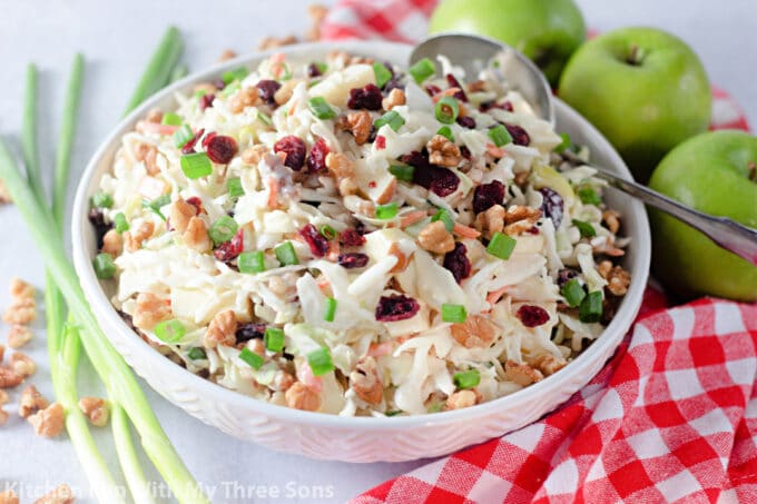Cranberry Apple Coleslaw in a white bowl with a red napkin.