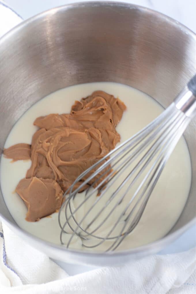 peanut butter and white chocolate in a metal mixing bowl.