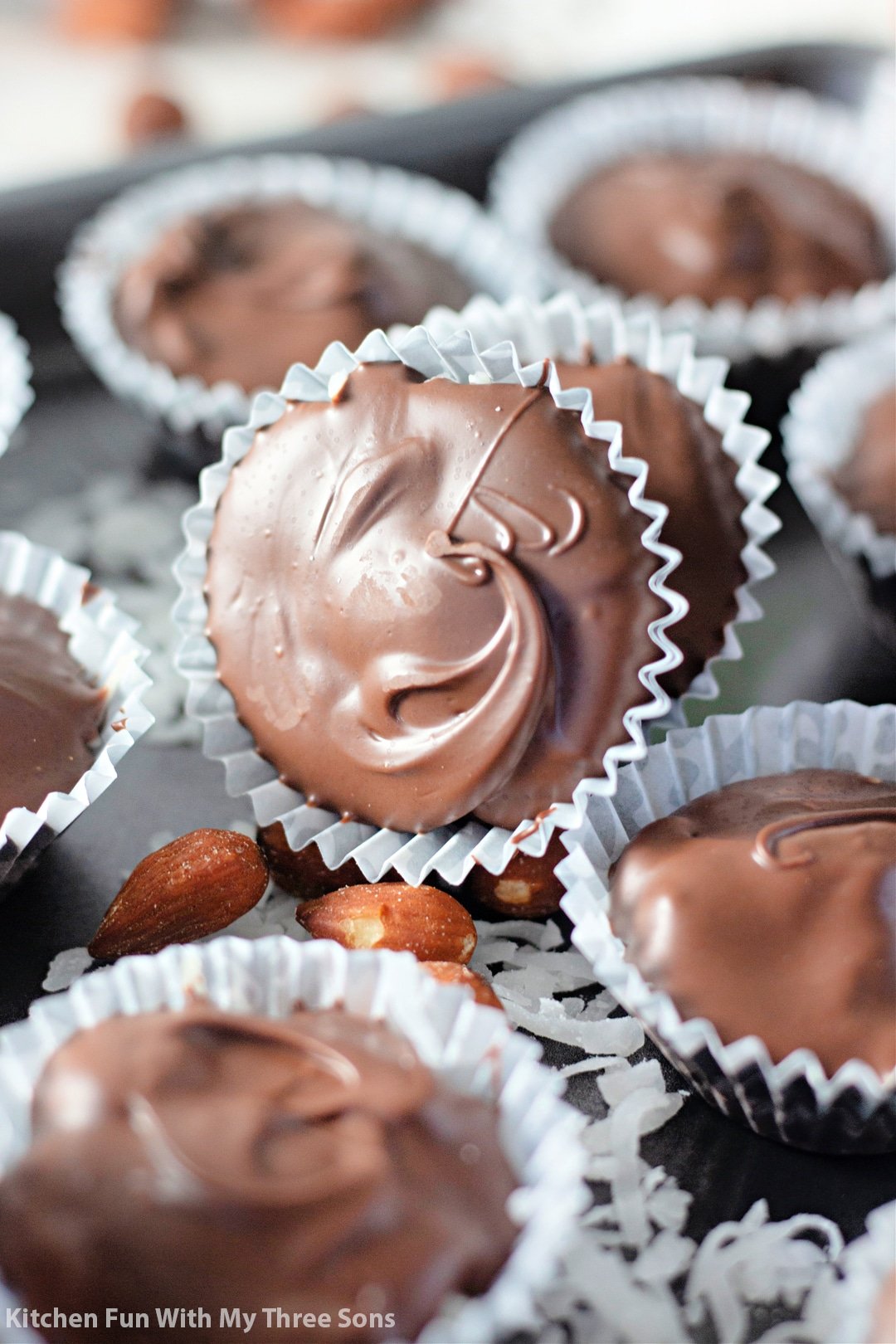 Homemade Almond Joy Recipe on a cookie sheet with almonds and coconut.