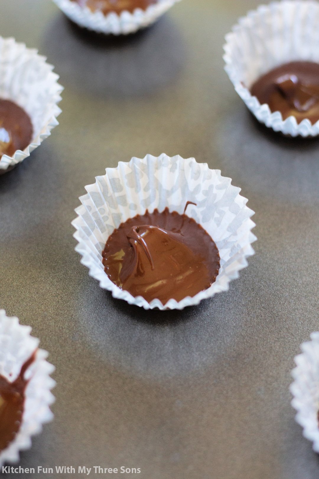 melted chocolate in the bottom of mini cupcake wrappers.