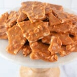 Homemade Peanut Brittle on a marble cake stand