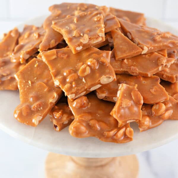 Homemade Peanut Brittle on a marble cake stand
