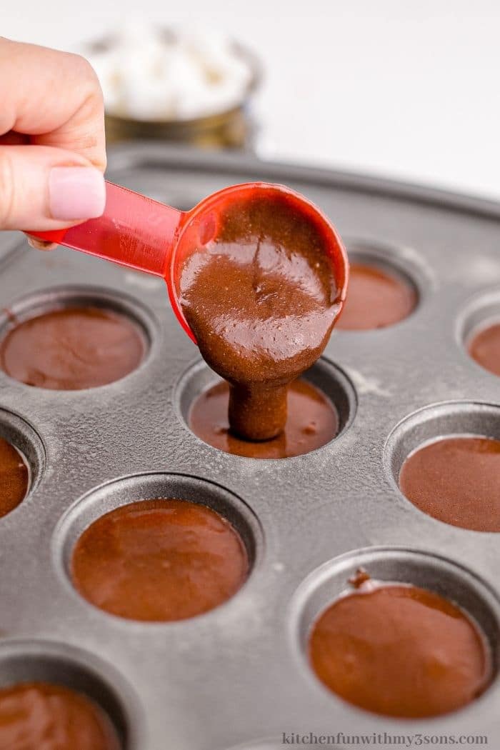 Adding the brownie batter into the prepared pan.