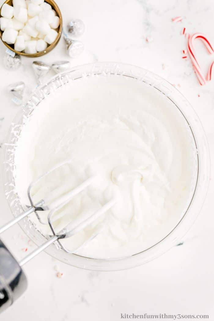Whipping the heavy cream.