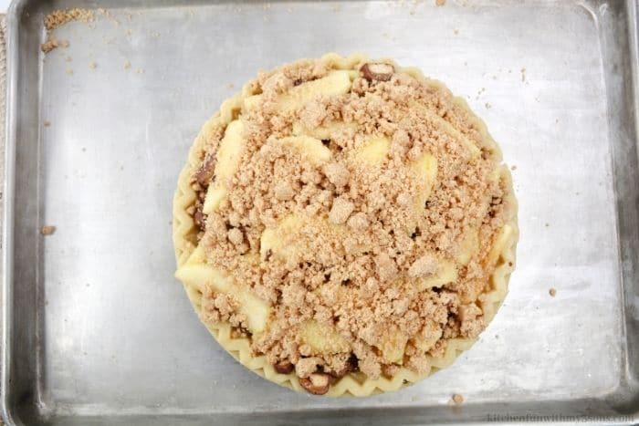 Adding the crumble on top of the pie.