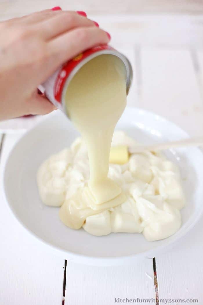 Adding in the condensed milk into the batter.