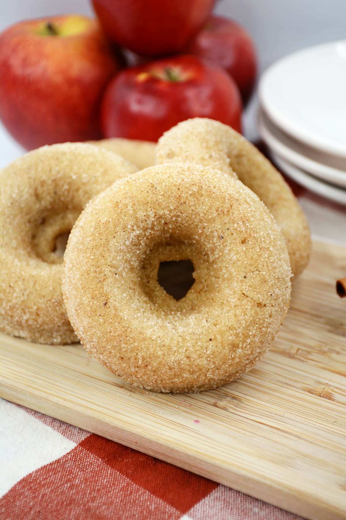 baked apple donuts on a brown cutting board