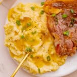 Overhead view of brown butter mashed potatoes and meat on a plate