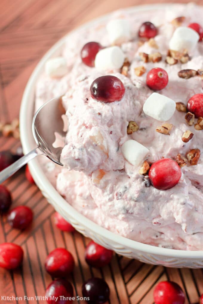 scooping Cranberry Fluff Salad with a spoon.