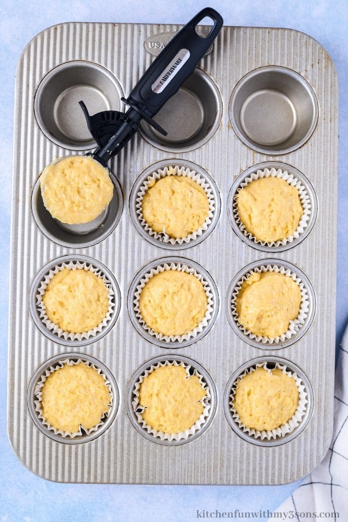 Adding the batter into the muffin tin.