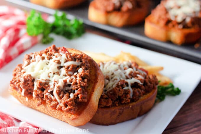 Garlic Bread Sloppy Joes on a white plate with a red and white napkin.