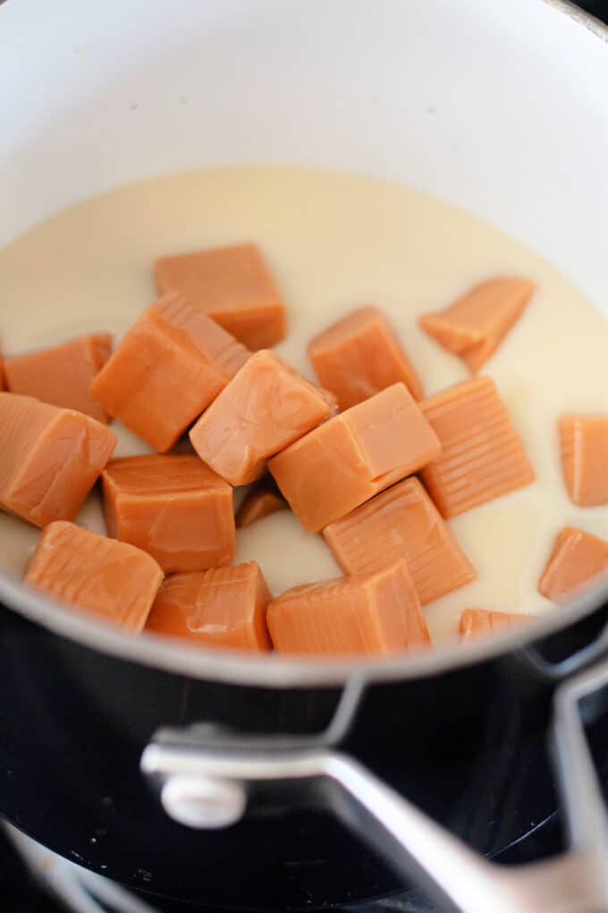 caramels and sweetened condensed milk in a saucepan.