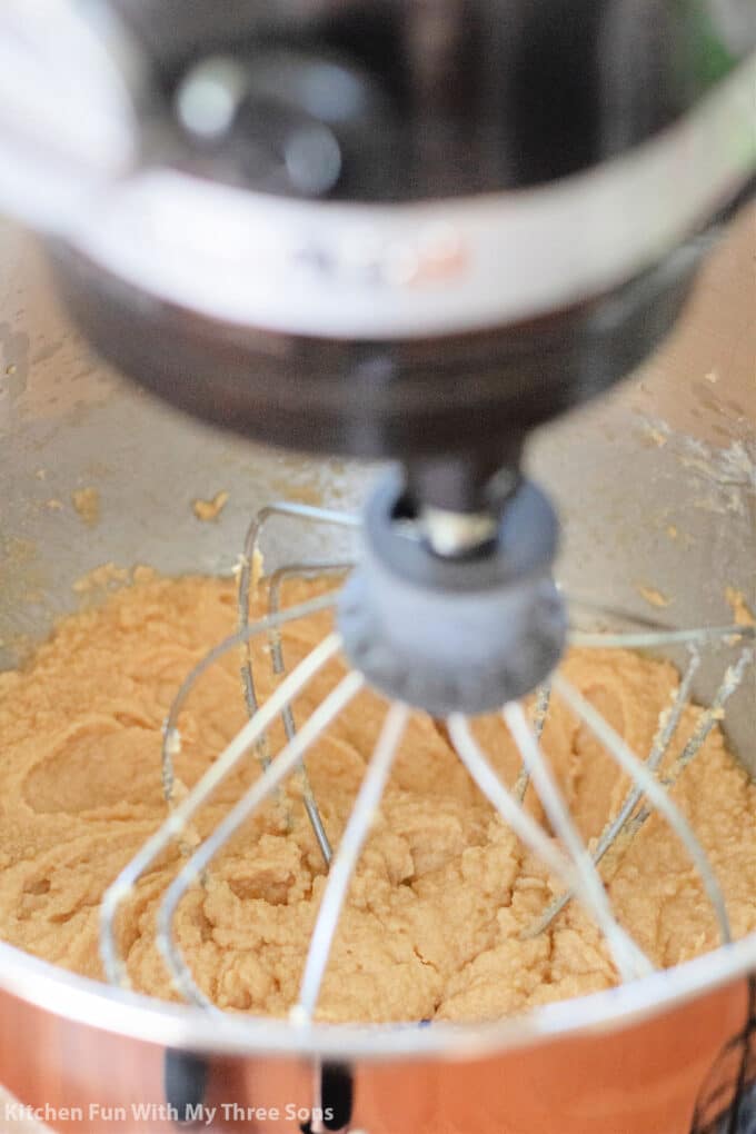 beating ingredients together in a KitchenAid mixer.