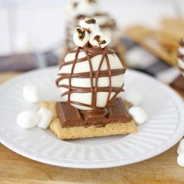 The cocoa bombs on a white serving plate.