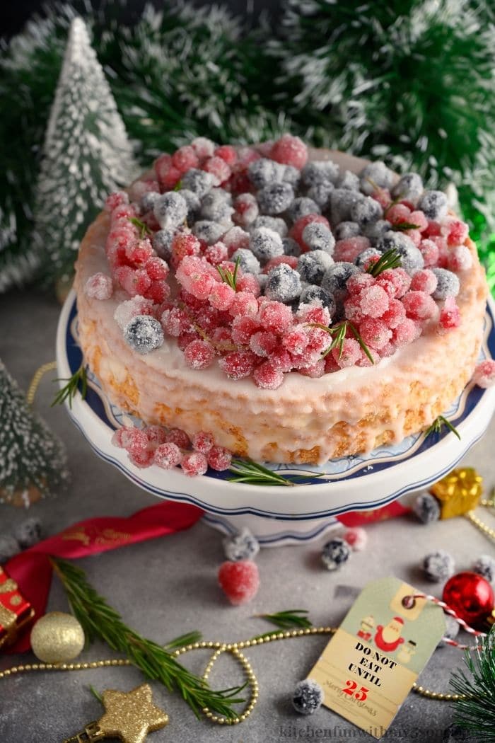 The whole cake topped with sugared-berries.