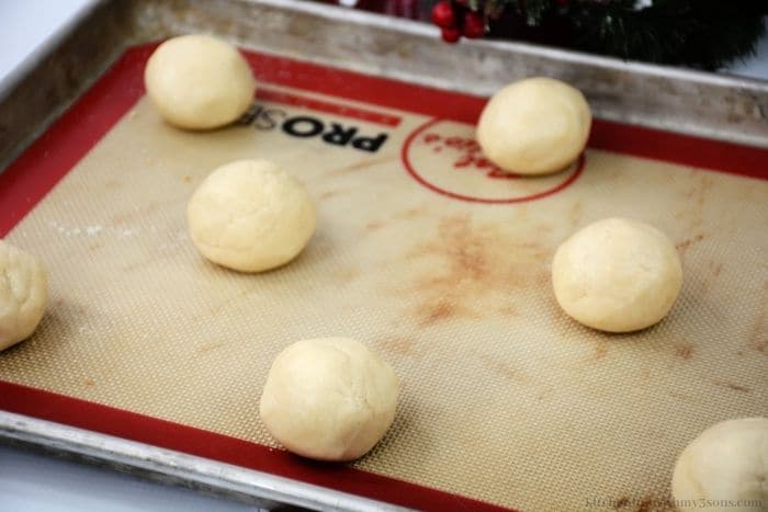 The dough balls arranged on the baking sheet.
