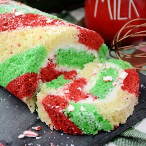 The rolled cake on a grey slate serving platter.