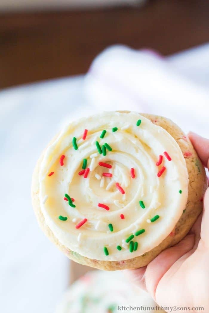 A hand holding up one of the Christmas Funfetti cookies.