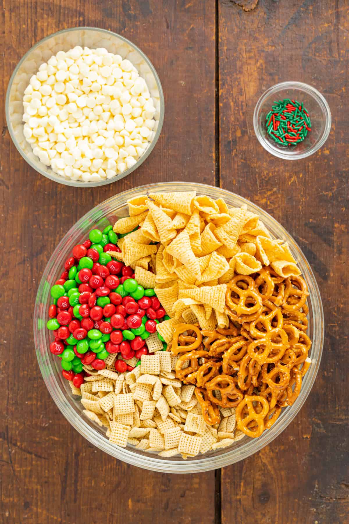 This Christmas Snack Mix (also referred to as White Trash Mix) is a favorite for the Holidays and takes just 10-minutes to make. Ingredients for Christmas Snack Mix