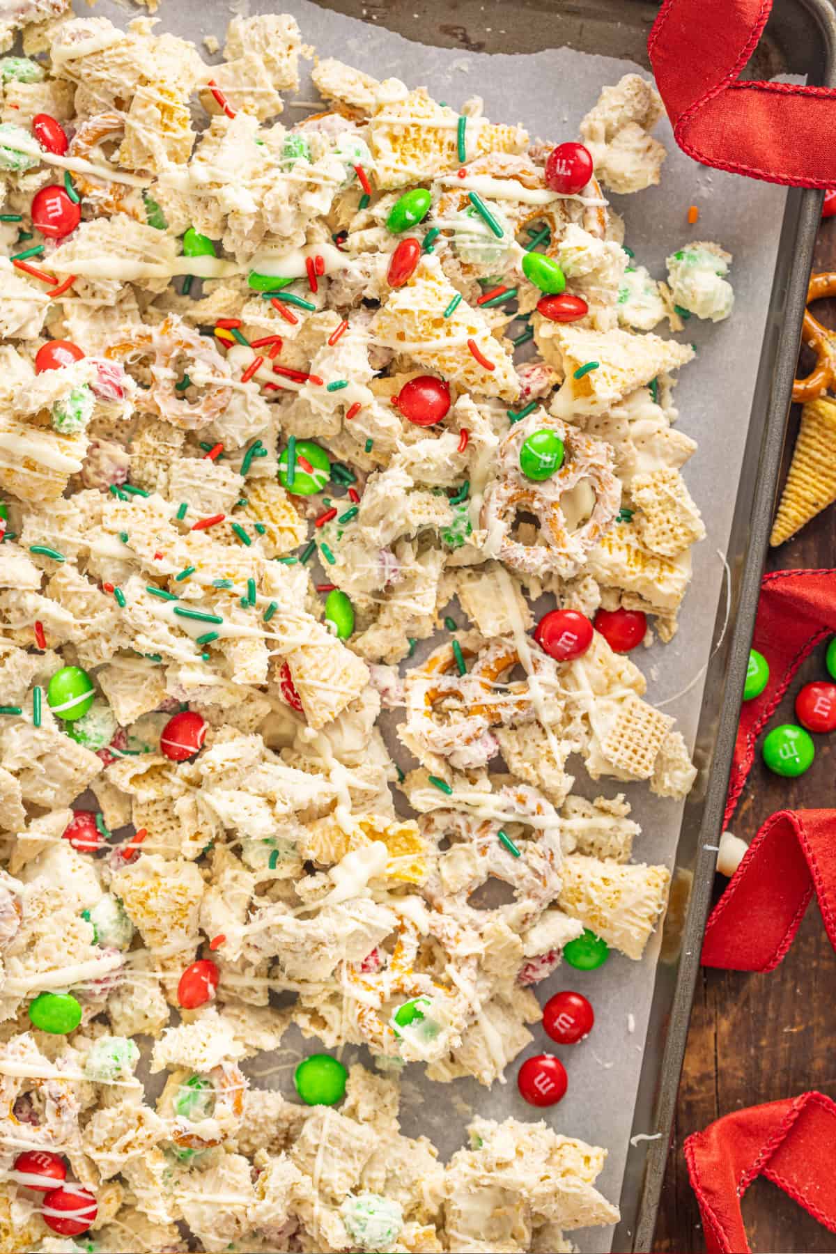 This Christmas Snack Mix (also referred to as White Trash Mix) is a favorite for the Holidays and takes just 10-minutes to make. Christmas Snack Mix on a cookie sheet