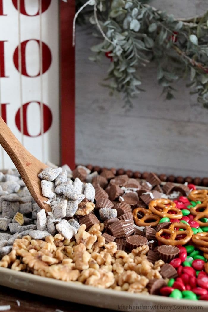 A spoon lifting up some of the christmas trail mix.