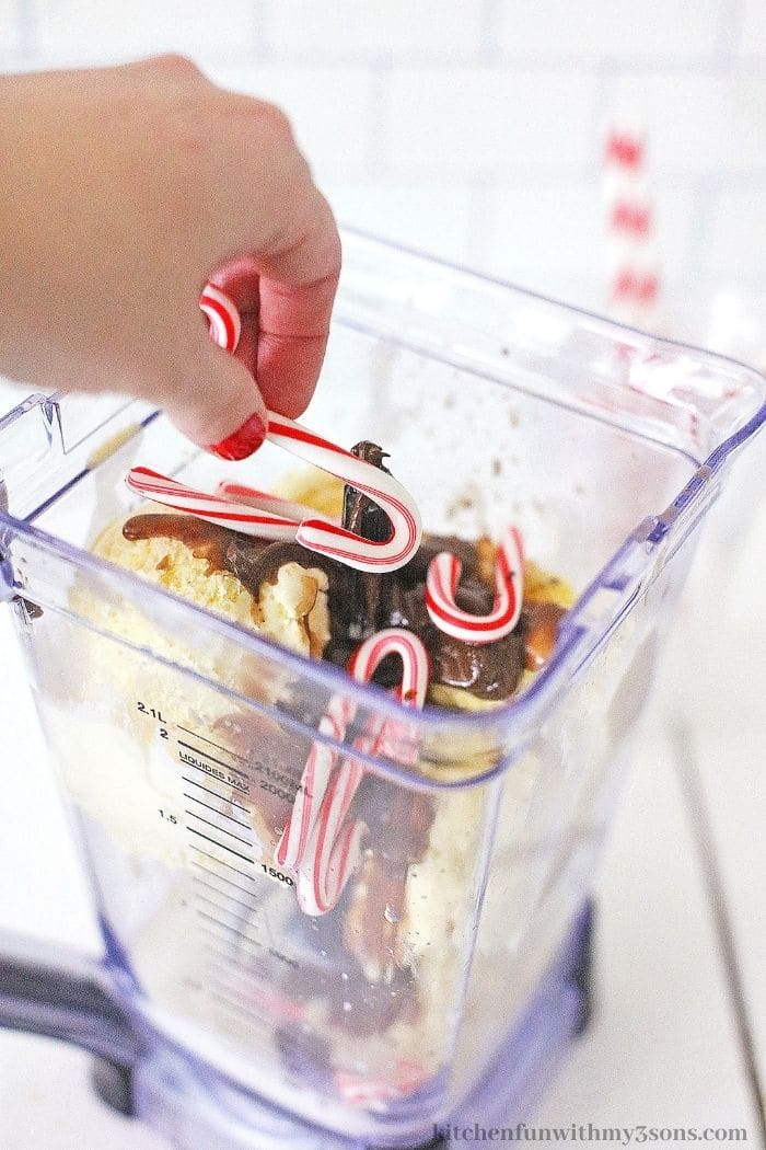 Adding the candy canes to the blender.