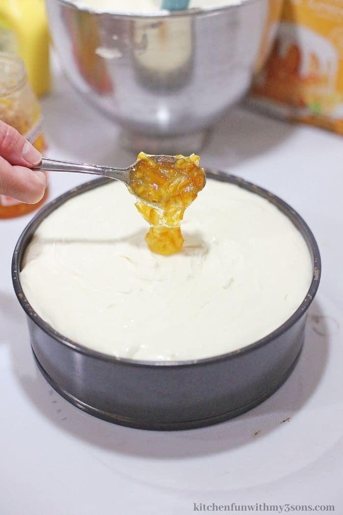 Adding the marmalade on top of the batter.